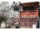 Private backyard with a small patio, mature trees, and decorative lattice offering a serene outdoor retreat at 14702 E Security Way, Aurora, CO 80011