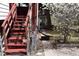 Exterior shot of backyard featuring wooden steps, chain link fence, and mature tree with white blossoms at 14702 E Security Way, Aurora, CO 80011