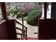 View of the backyard from the porch with lush greenery, trees, and partial view of a home at 14702 E Security Way, Aurora, CO 80011