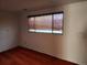 Bare bedroom featuring neutral carpet, white walls, and a window with wood-look blinds at 14702 E Security Way, Aurora, CO 80011