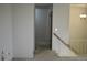 This hallway features neutral walls, staircase, and carpeted floors at 14702 E Security Way, Aurora, CO 80011