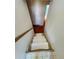 Carpeted stairway with a handrail leading to the lower level of the home at 14702 E Security Way, Aurora, CO 80011