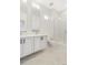 Modern bathroom featuring dual vanities, a walk-in shower, and elegant tile flooring at 5725 W 91St Ave, Westminster, CO 80031