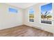 Sun-filled bedroom featuring light wood floors and large windows with neighborhood views at 5725 W 91St Ave, Westminster, CO 80031