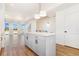 Bright, open kitchen featuring a kitchen island and hardwood floors leading to living area at 5725 W 91St Ave, Westminster, CO 80031