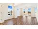 Bright and spacious living room with large windows, showcasing hardwood floors at 5725 W 91St Ave, Westminster, CO 80031