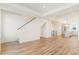 Open concept living area with hardwood floors leading to staircase and kitchen at 5725 W 91St Ave, Westminster, CO 80031