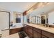 Luxurious bathroom featuring a soaking tub, walk-in shower, dual vanities, and elegant fixtures for spa-like experience at 10776 Hillsboro Cir, Parker, CO 80134