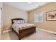 Cozy bedroom with wooden bed frame, soft carpet, window with blinds, and natural lighting creating a peaceful atmosphere at 10776 Hillsboro Cir, Parker, CO 80134