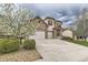 Charming two-story home with stone accents, red shutters, three-car garage, and well-manicured lawn at 10776 Hillsboro Cir, Parker, CO 80134