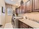 Well-appointed laundry room with ample cabinetry, granite countertops, and modern washer and dryer units at 10776 Hillsboro Cir, Parker, CO 80134