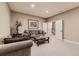 Cozy living room featuring plush seating and neutral tones with a staircase visible through white double doors at 10776 Hillsboro Cir, Parker, CO 80134