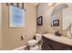 Charming powder room with neutral tones, stylish fixtures, and a round mirror for a welcoming ambiance at 10776 Hillsboro Cir, Parker, CO 80134