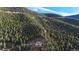 Stunning mountain home nestled amongst tall trees on a vast hillside at 900 Sawmill Creek Rd, Evergreen, CO 80439