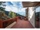 Cozy outdoor seating on a wooden deck overlooking mountain landscape at 900 Sawmill Creek Rd, Evergreen, CO 80439