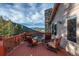 Outdoor seating area with mountain views from a rustic wood deck at 900 Sawmill Creek Rd, Evergreen, CO 80439