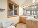 Well-lit bathroom features a double vanity, wood cabinets, tile floors, and a large view window at 900 Sawmill Creek Rd, Evergreen, CO 80439