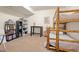 Spacious bedroom featuring a wood framed bunk bed, desk, and shelving for storage at 900 Sawmill Creek Rd, Evergreen, CO 80439