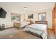Bright bedroom with a log bed frame, a second bed, and carpet floors at 900 Sawmill Creek Rd, Evergreen, CO 80439