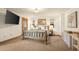 Comfortable bedroom featuring a rustic wood bed frame, soft carpet, and a serene view from multiple windows at 900 Sawmill Creek Rd, Evergreen, CO 80439
