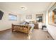 Cozy bedroom featuring a log bed frame, two large windows, and rustic decor at 900 Sawmill Creek Rd, Evergreen, CO 80439