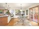Dining area featuring hardwood floors, a round glass table with seating, and large windows offering scenic views at 900 Sawmill Creek Rd, Evergreen, CO 80439