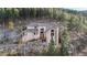 Secluded mountain home with stone accents and wooden deck nestled amongst trees at 900 Sawmill Creek Rd, Evergreen, CO 80439