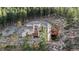 Secluded mountain home with stone accents and wooden deck nestled amongst trees at 900 Sawmill Creek Rd, Evergreen, CO 80439