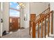 Bright foyer with high ceilings, large windows and grand staircase at 900 Sawmill Creek Rd, Evergreen, CO 80439