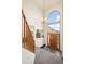 Elegant foyer with a view of the fireplace, staircase, and scenic outdoors through the front door at 900 Sawmill Creek Rd, Evergreen, CO 80439