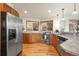Well-lit kitchen with stainless steel appliances, light wood cabinets, granite countertops, and a scenic view at 900 Sawmill Creek Rd, Evergreen, CO 80439