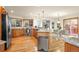 Open kitchen featuring stainless steel appliances, granite counters, hardwood floors and a dining area with a view at 900 Sawmill Creek Rd, Evergreen, CO 80439