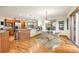 Bright, open kitchen with stainless steel appliances, granite counters, and hardwood floors plus a glass table and view at 900 Sawmill Creek Rd, Evergreen, CO 80439