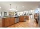 Spacious kitchen with wood cabinets, granite counters, stainless steel appliances, and hardwood floors at 900 Sawmill Creek Rd, Evergreen, CO 80439