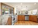 Bright kitchen with stainless steel appliances, granite countertops, wood cabinets, and a scenic outdoor view at 900 Sawmill Creek Rd, Evergreen, CO 80439