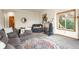 Cozy living room features couches, large windows, and an exercise machine at 900 Sawmill Creek Rd, Evergreen, CO 80439