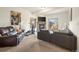 Open living room with a stone fireplace, large windows and comfortable seating area at 900 Sawmill Creek Rd, Evergreen, CO 80439