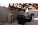 Outdoor living space featuring stone flooring, custom wood fireplace, lighting, and wood beam awning at 1751 Clermont St, Denver, CO 80220