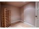 Basement storage room features tile floors, baseboard trim, and access to the rest of the finished basement at 1751 Clermont St, Denver, CO 80220