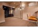 Basement area features bar seating and lighting, with a connecting space to a media room at 1751 Clermont St, Denver, CO 80220