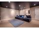 Spacious basement featuring plush seating, modern lighting, and access to other rooms in the home at 1751 Clermont St, Denver, CO 80220