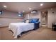 Finished basement features a pull-out sofa bed with bright lighting and convenient access to other areas of the home at 1751 Clermont St, Denver, CO 80220