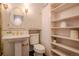 A clean bathroom with vintage gold fixtures, classic shelving at 1751 Clermont St, Denver, CO 80220