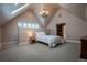 A cozy bedroom with white comforter, chandelier, and walk-in closet at 1751 Clermont St, Denver, CO 80220