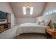 A cozy bedroom with white comforter, chandelier, and skylights at 1751 Clermont St, Denver, CO 80220