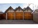 Detached multi-car garages boasting wood doors and Tudor-style accents, providing ample parking and storage space at 1751 Clermont St, Denver, CO 80220