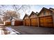 Detached multi-car garages boasting wood doors and Tudor-style accents, providing ample parking and storage space at 1751 Clermont St, Denver, CO 80220
