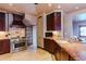 Elegant kitchen featuring stainless steel appliances, custom cabinets, and a granite countertop island at 1751 Clermont St, Denver, CO 80220