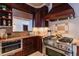 Modern kitchen with stainless steel stove, custom wooden cabinets, and beautiful granite countertops at 1751 Clermont St, Denver, CO 80220