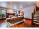 Bright living room boasts gleaming hardwood floors, fireplace, and staircase at 1751 Clermont St, Denver, CO 80220